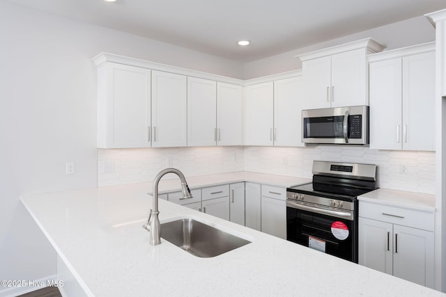 kitchen featuring white cabinetry, appliances with stainless steel finishes, and sink