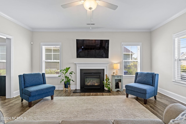 living room featuring ornamental molding, dark wood-type flooring, and ceiling fan