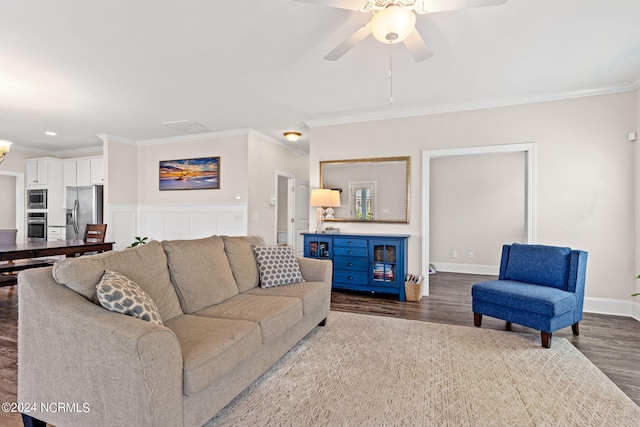 living room featuring ornamental molding, dark wood-type flooring, and ceiling fan