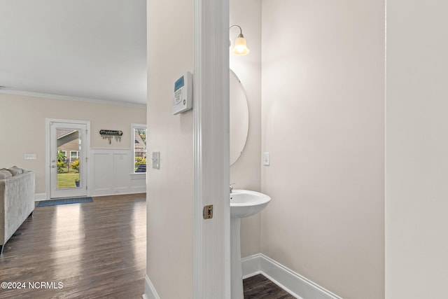 bathroom with crown molding and wood-type flooring