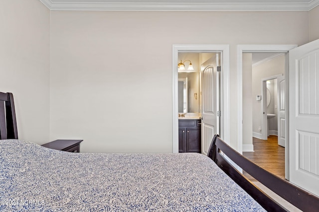 bedroom with ornamental molding, hardwood / wood-style floors, and ensuite bathroom