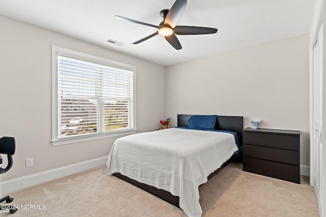 bedroom with light colored carpet and ceiling fan