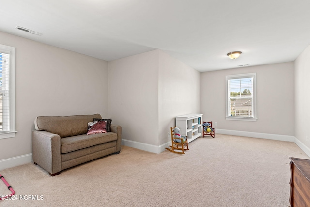 living area with light colored carpet