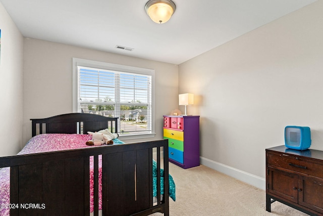 bedroom featuring light carpet