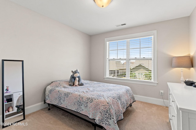 bedroom featuring light colored carpet