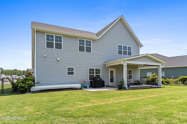 rear view of house with a yard and a patio area