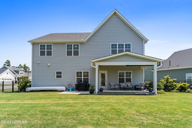 back of house with a yard and a patio area