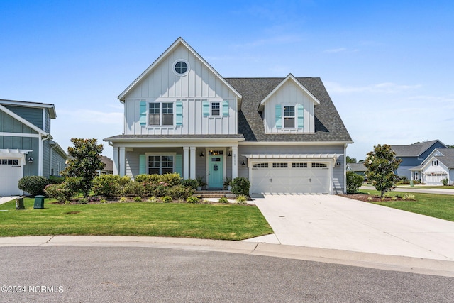 view of front of house with a front lawn, covered porch, and a garage