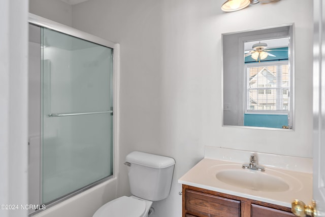 full bathroom featuring vanity, toilet, and enclosed tub / shower combo