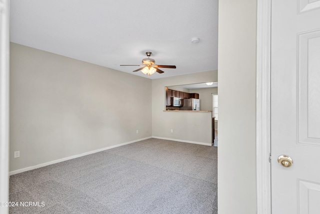 unfurnished living room with ceiling fan and light carpet