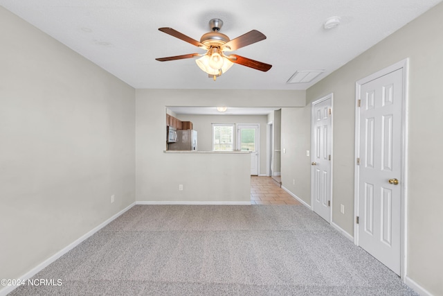 unfurnished living room with ceiling fan and light carpet