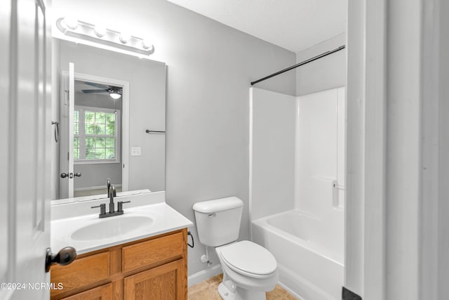 full bath with a ceiling fan, toilet, tile patterned floors,  shower combination, and vanity