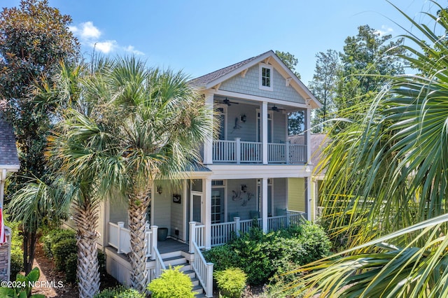 view of front of property featuring covered porch, a balcony, and ceiling fan