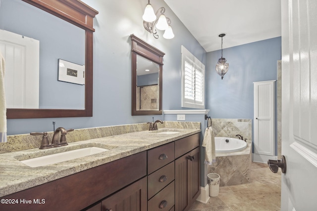 bathroom featuring double vanity, a sink, and a bath