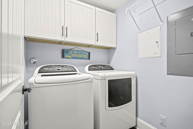 clothes washing area with cabinet space, washer and clothes dryer, and electric panel