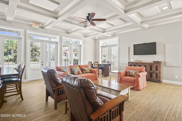 living room with beamed ceiling, french doors, coffered ceiling, and ceiling fan