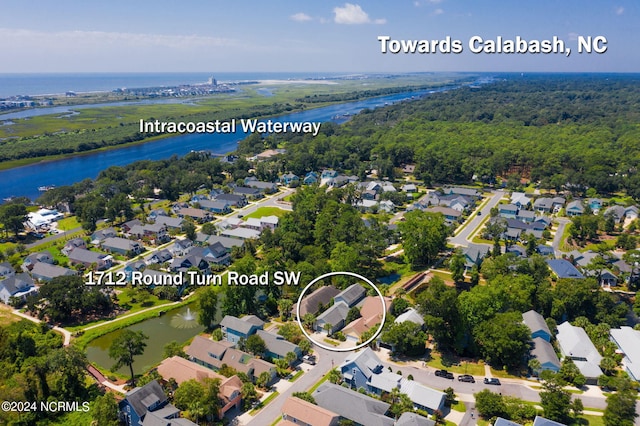 drone / aerial view with a water view and a residential view