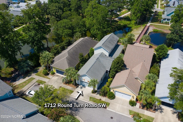 birds eye view of property with a water view and a residential view