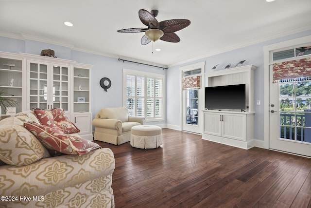 living room featuring dark wood-type flooring, ceiling fan, and ornamental molding