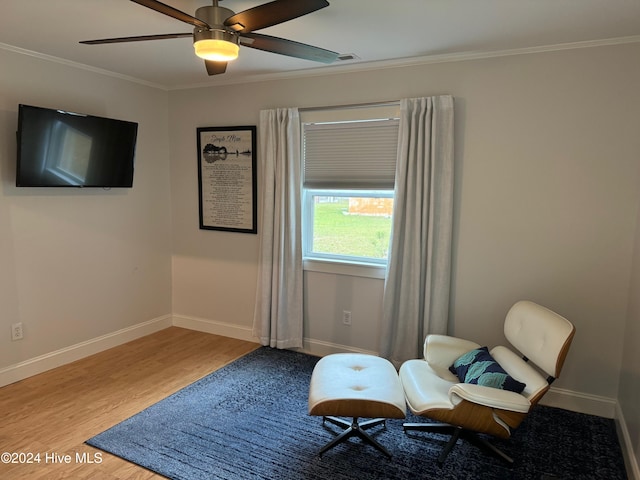 sitting room with ceiling fan, hardwood / wood-style floors, and ornamental molding