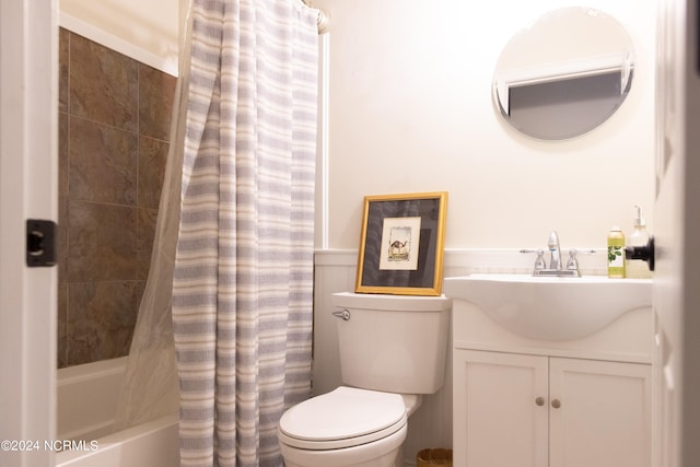 full bathroom featuring vanity, shower / tub combo, and toilet