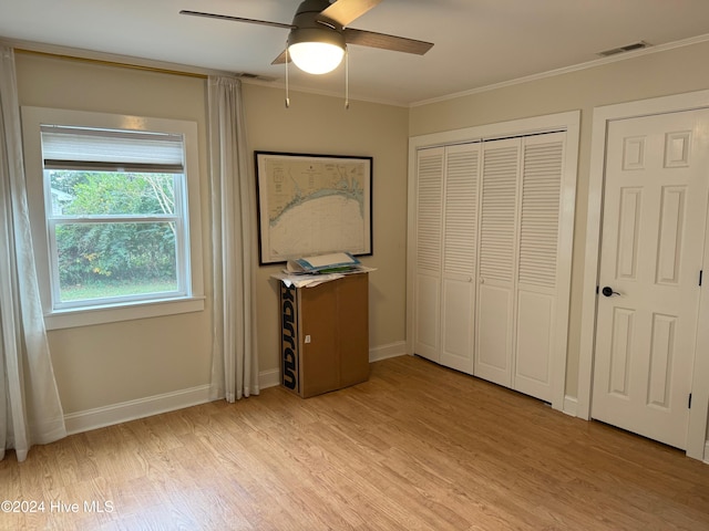 unfurnished bedroom featuring ceiling fan, light hardwood / wood-style flooring, and crown molding