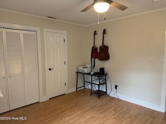 bedroom with ceiling fan, light wood-type flooring, and crown molding