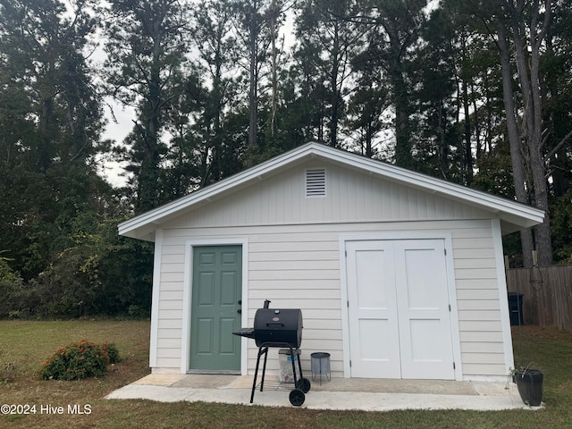 view of outbuilding with a yard