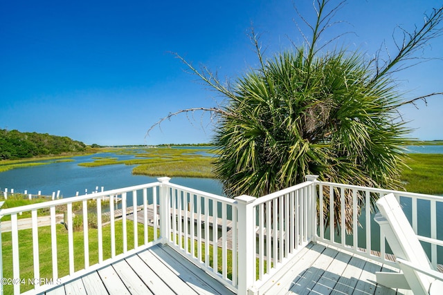 wooden deck featuring a yard and a water view