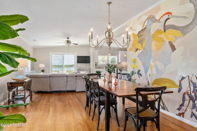 dining room with ornamental molding, ceiling fan with notable chandelier, and light hardwood / wood-style floors