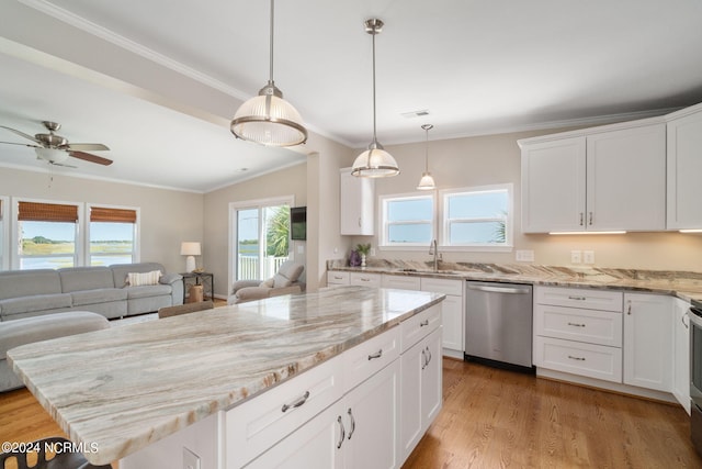 kitchen featuring white cabinetry, sink, a kitchen island, and appliances with stainless steel finishes