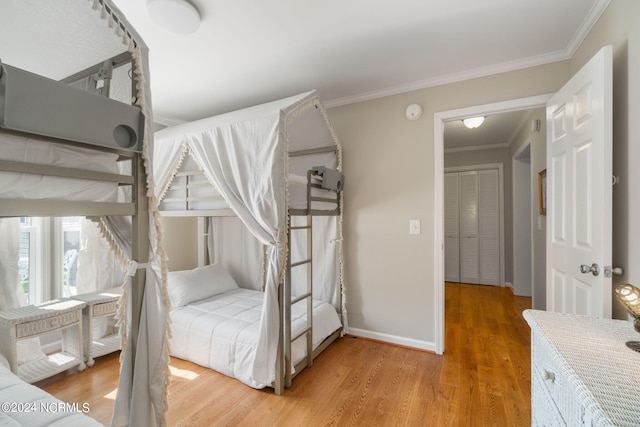 bedroom with ornamental molding and light hardwood / wood-style floors