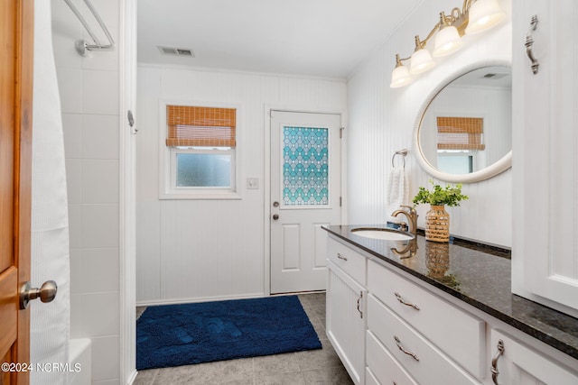 bathroom featuring tile patterned flooring, vanity, and bathtub / shower combination