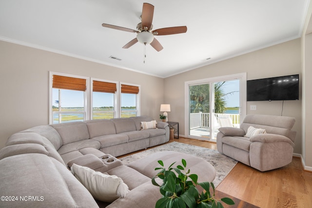 living room with ceiling fan, ornamental molding, a healthy amount of sunlight, and light wood-type flooring