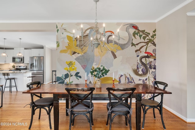 dining area featuring crown molding, an inviting chandelier, and light hardwood / wood-style flooring