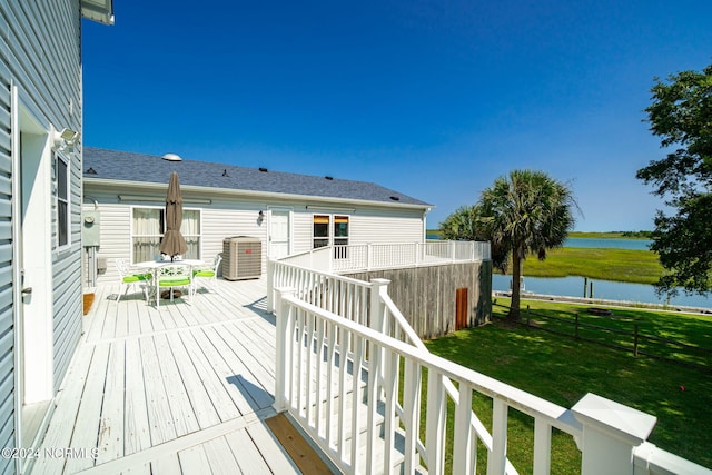 deck featuring a lawn and a water view