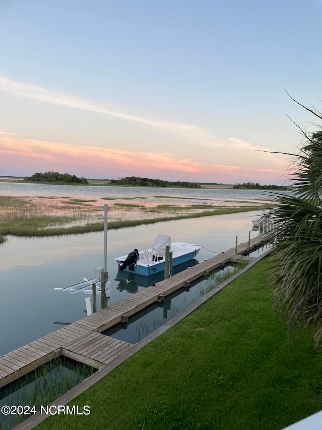 view of dock featuring a yard and a water view