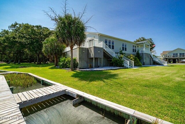 rear view of property with a lawn