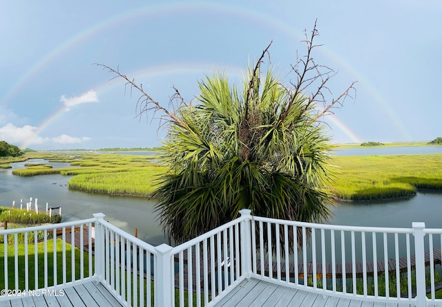 wooden terrace featuring a water view