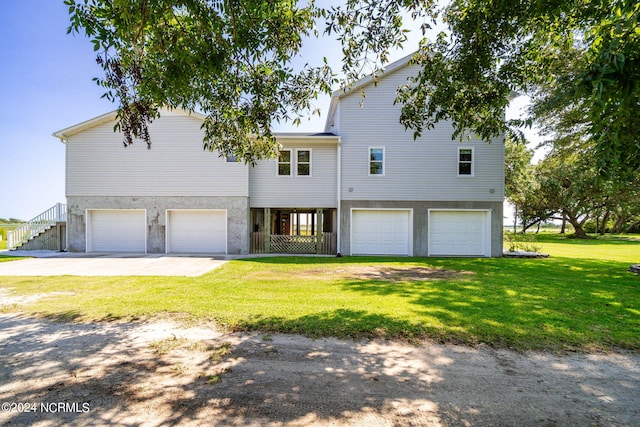 view of front of property featuring a garage and a front lawn