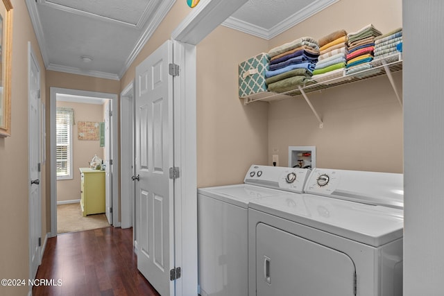 clothes washing area with dark wood-style floors, ornamental molding, laundry area, independent washer and dryer, and baseboards