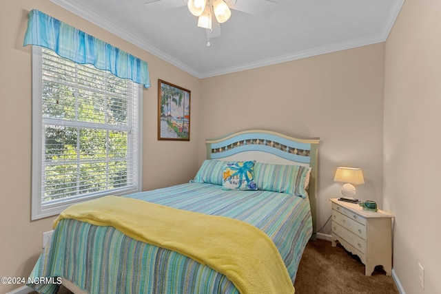 carpeted bedroom with baseboards, ornamental molding, and a ceiling fan