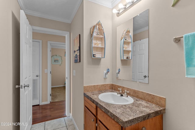 bathroom with vanity, visible vents, crown molding, and tile patterned floors