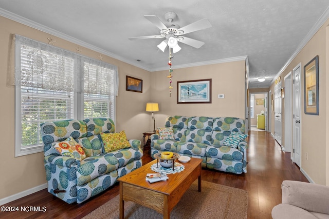 living room featuring ornamental molding, a ceiling fan, baseboards, and wood finished floors