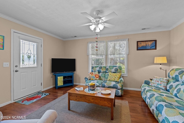 living area with crown molding, visible vents, ceiling fan, a textured ceiling, and wood finished floors