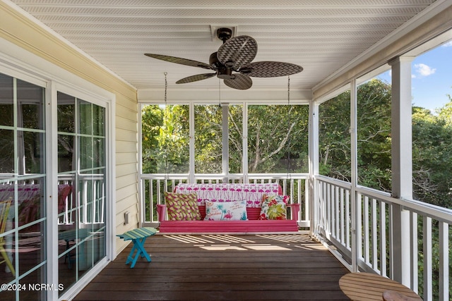 unfurnished sunroom featuring ceiling fan