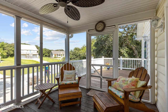 sunroom / solarium with a ceiling fan