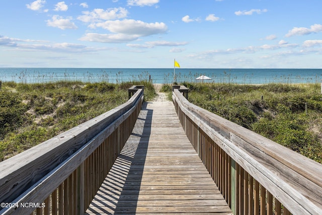 surrounding community featuring a water view and a view of the beach