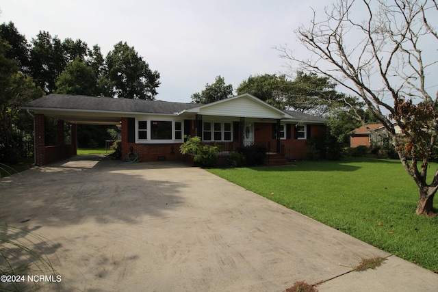 ranch-style house featuring a carport and a front lawn