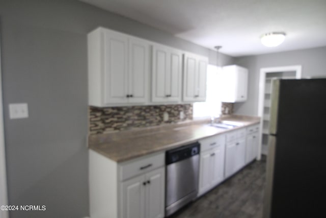 kitchen featuring decorative backsplash, fridge, white cabinetry, and stainless steel dishwasher